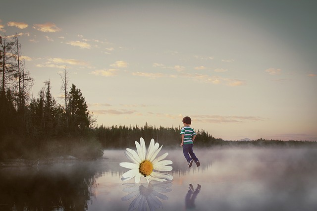 child on standing on a lake
